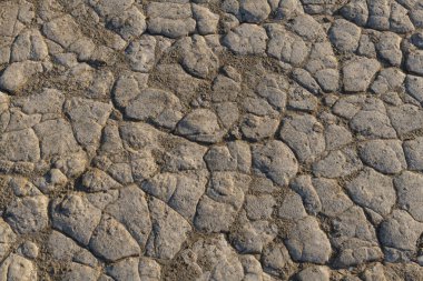 Dried mud texture. Dried mud waves from the mud volcanos site in Berca, Buzau, Romania. clipart