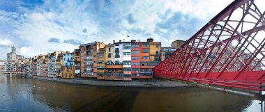 Girona, panoramic view with the houses of the Onyar river and the Eiffel bridge. Catalonia Spain clipart