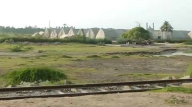 Passing By Train Rails In Front Of Field - Slide - Left To Right