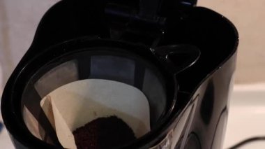 filling up coffee machine with water - close up