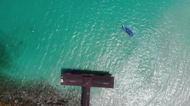 島の透明度の高い海に浮かぶ船のドローンビュー — ストック動画