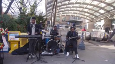 Busking Musicians Playing Near Subway Entrance - Static