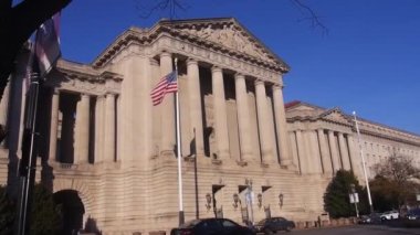 Monument Frontage With American Flags Near Cars - Static