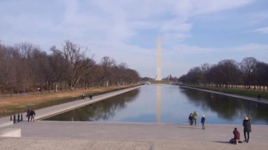 People Walking Near Water Source, Trees And Monument - Static