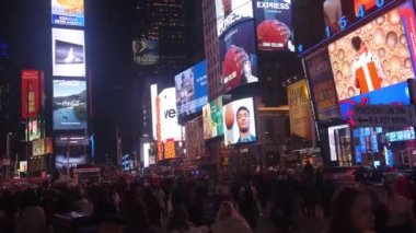 Adverts On Buildings In Street Over Crowd - Pan - Right To Left