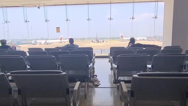亚洲男人在机场跑道前的椅子上等着 — 图库视频影像