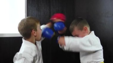 Two athletes with red and blue overlays on their hands perform paired exercises