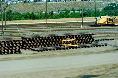 Kamloop, Canada - 22nd June 2023:Yellow lifting block attached to the replacement railway sections of track clipart