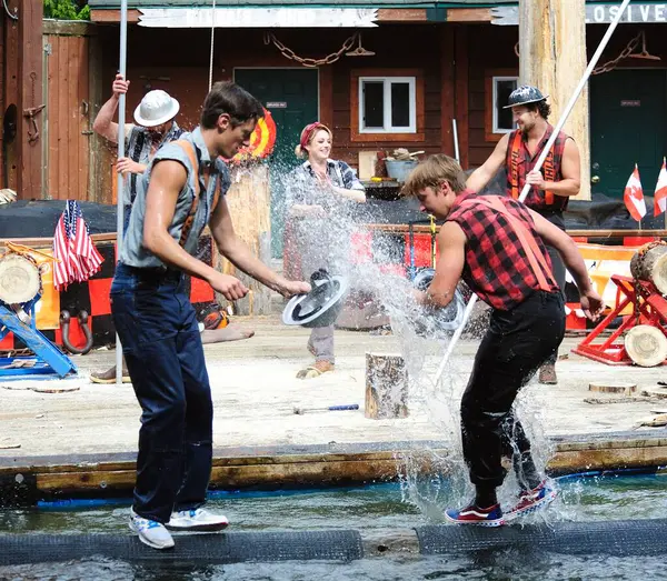 stock image Ketchikan, Alaska, USA - 1st July 2023:Lumberjacks having a water fight on a floating log