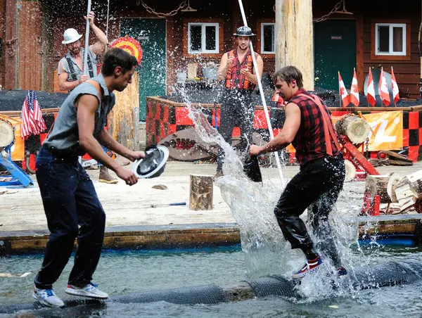 stock image Ketchikan, Alaska, USA - 1st July 2023:Lumberjacks having a water fight on a floating log