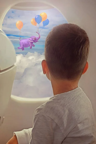 Little Boy Looking Out Window While Flying Airplane Elephant Flying — Stock Photo, Image