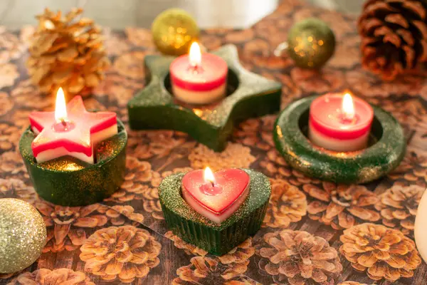 Tealight holder with burning candles for Christmas in green with glitter dust