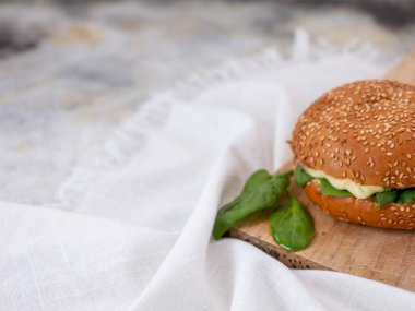 sandwich with cheese ham and spinach with concrete background. 