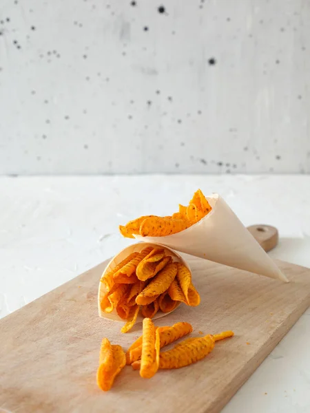 Tortilla chips prepared for a party snack. White kitchen