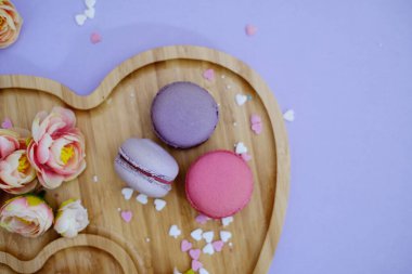 French macaroons in a heart shaped plate served for valentines day. Flat lay photo