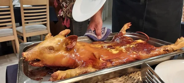 roasted pig in metal baking tray