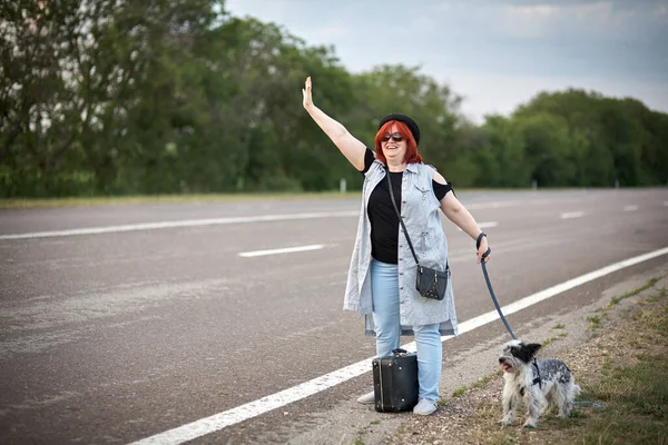 stock image Womenon the road with dog stoped auto