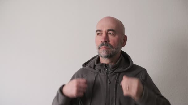 Adult Serious Bearded Man Putting Gray Hood Looking Camera Studio — Vídeo de Stock