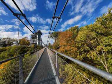 Thale , Saxony-Anhalt , Germany - 02 10 2023: Pedestrian suspension bridge with a length of 483 m above the Rappbode dam Bode river in Harz Mountains National Park, near Thale, Germany clipart