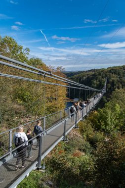 Thale , Saxony-Anhalt , Germany - 02 10 2023: Pedestrian suspension bridge with a length of 483 m above the Rappbode dam Bode river in Harz Mountains National Park, near Thale, Germany clipart