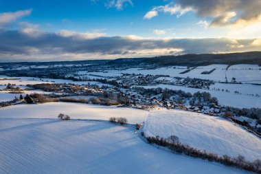 Kış. Gün batımında yoğun karla kaplı küçük bir Alman dağ köyünün hava manzarası. Almanya.