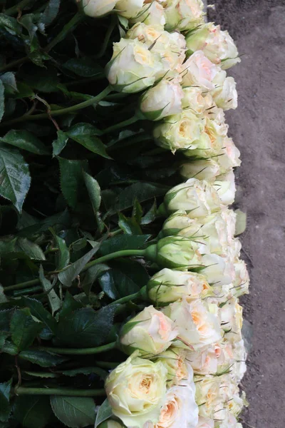white colored rose bouquet on shop for sell are cash crops