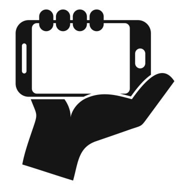 El akıllı telefonu tutuyor, sanki birine sunuyormuş gibi.