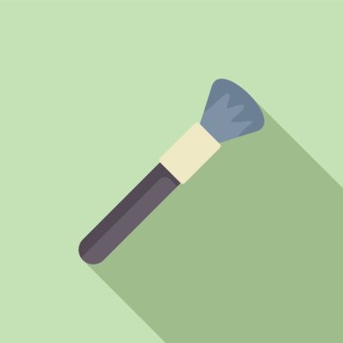 Makyaj fırçası, uzun gölgeli yeşil bir arka planda çapraz olarak yatar.