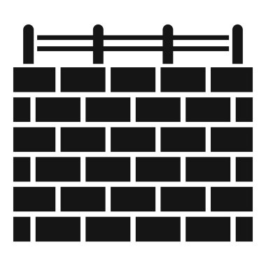 Üzerinde metal bir çit olan tuğla bir duvarın siyah siluet simgesi