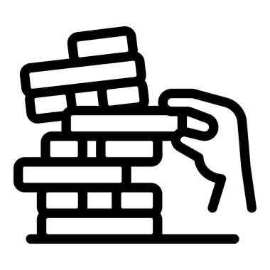 El dikkatlice yüksek tahta bloklardan oluşan bir kuleden bir blok kaldırıyor ve klasik Jenga oyunu oynuyor.