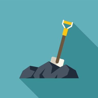 Kürek kömür yığınını eşeliyor, maden çıkarma konseptini gösteriyor.