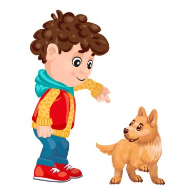 Mutlu genç çocuk işaret ediyor ve sevimli köpek yavrusunu eğitiyor.