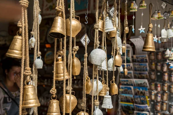 stock image Copper bells hanging on a tree on market.