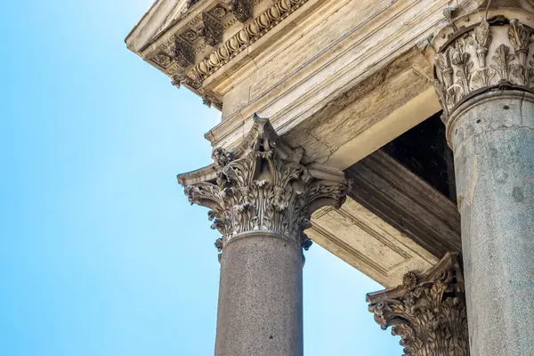 Ionian column capital, architectural detail. Low angle view of the roman architectural details of a building.