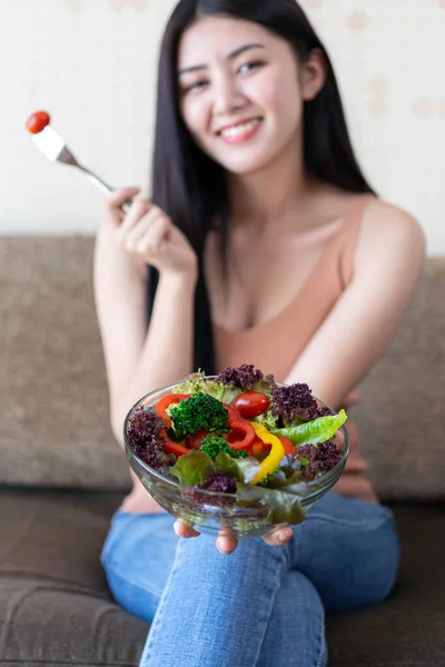 아리따운 동양인귀여운 아가씨는 건강을 샐러드를 먹으면서 행복을 느끼고 집에서 침실에서 — 스톡 사진