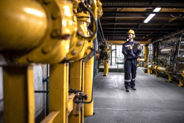 Heating worker engineer controlling heat production inside power plant.