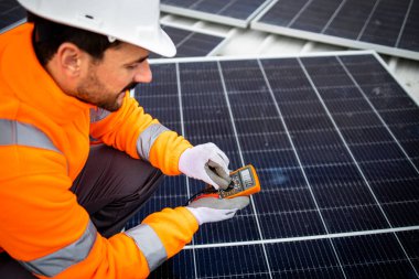 Checking voltage and electricity of solar photovoltaic panels on the roof.
