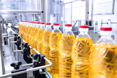 Production line of bottled vegetable on conveyor belt machine.