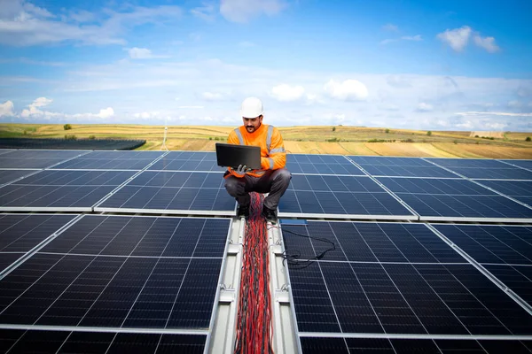 Μηχανικός Εγκαταστάσεων Ηλιακής Ενέργειας Στέκεται Μεταξύ Φωτοβολταϊκών Πάνελ Και Τον — Φωτογραφία Αρχείου