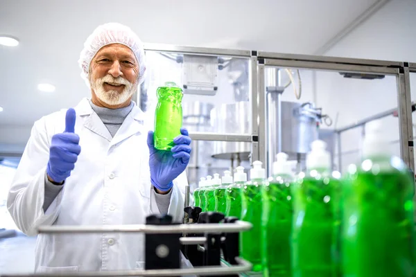 Portrait of experienced factory supervisor approving production of sanitation chemicals and detergents.