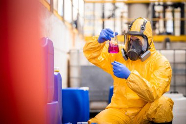 Quality control worker in chemicals production factory testing quality of chemical.