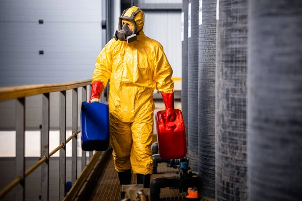 stock image Working with dangerous chemicals inside factory.