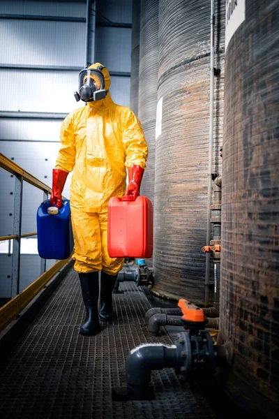 stock image Working in metal galvanizing factory. Worker in protective equipment carrying necessary chemicals and acids.