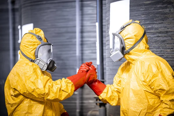 stock image Factory workers teamwork. Two industrial employees greeting with hands in protection gloves.