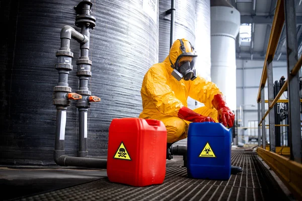 stock image Chemicals industry for acid production. Factory worker in hazmat protective suit and gas mask carefully working with hazardous materials.