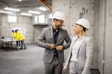 İnşaat işi - mimar ve iç mimar inşaat alanını ziyaret ediyor ve yeni proje planı hakkında tartışıyorlar