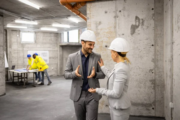 stock image Architect and structural engineer visiting construction site and discussing about new project plan.