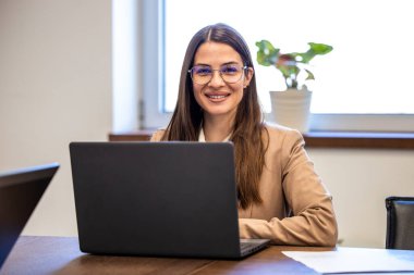 Ofisteki dizüstü bilgisayarda çalışan iş kadınının portresi..