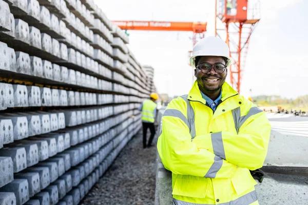 stock image Portrait of railroad construction engineer standing by concrete sleepers for building the tracks.