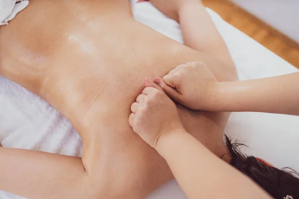 Female therapist relaxing with hand massage at beauty spa.